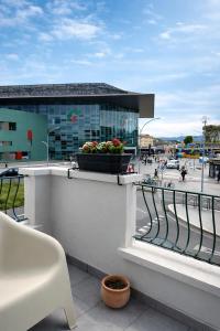 a balcony with a pot of flowers on a building at BEDS&ROOMS TIBURTINA - Beds, Posti letto in Rome