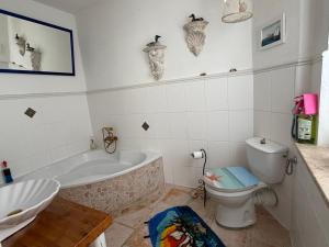 a bathroom with a tub and a toilet and a sink at Ferienwohnung Sieg in Mittelhof