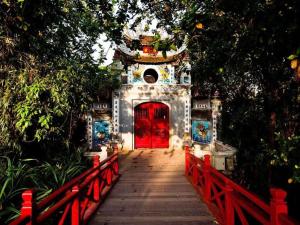 a red door in a building with a red bridge at Hanoi Amie Duplex Homestay in Hanoi +20 photos