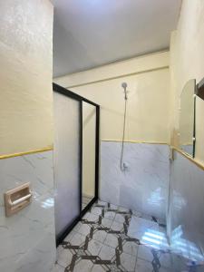 a bathroom with a shower with a glass door at Villa Nicolasa in Siquijor +36 photos