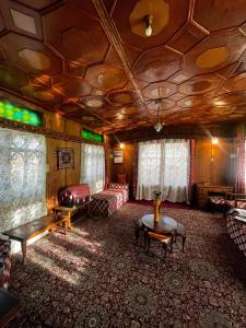 a living room with a couch and a table at Houseboat Nightingale in Srinagar