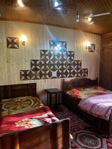 a hotel room with two beds and a camera at Houseboat Nightingale in Srinagar