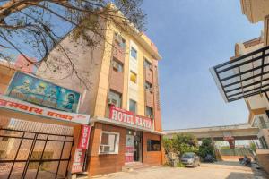 a building with a sign on the side of it at Hotel Kanha in Haridwār
