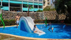 a group of people playing on a water slide in a pool at Gran Evenia Bijao - All Inclusive in Playa Blanca +43 photos