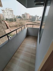 a room with a balcony with a view of a city at Comfort nest in Manipal in Manipal