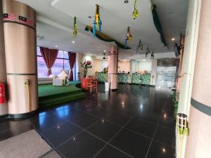 a large living room with a room with a couch and a room with a room at Melaka City Hotel in Malacca
