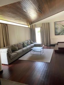 a living room with a couch and a table at Barcelos Residence Living in Barcelos