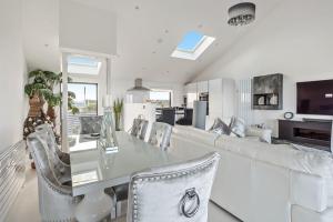 a living room with a glass table and a couch at Washington Beach House with Lodge in Heacham