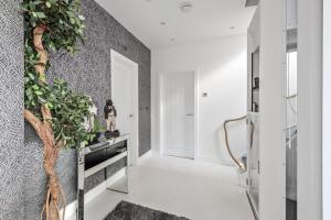 a living room with a tree on the wall at Washington Beach House with Lodge in Heacham +40 photos