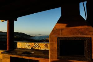 a fireplace with a view of the water at Casas 1 Terrace in Laguna +6 photos