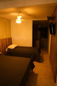 a hotel room with two beds and a television at Casas 1 Terrace in Laguna