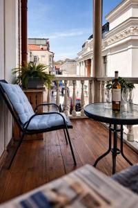 a balcony with a table and a bottle of wine at Tbil Inn Hotel in Tbilisi City