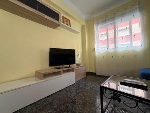 a living room with a flat screen tv on a wall at Brisa del Puerto in Puerto de Sagunto