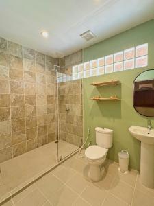 a bathroom with a shower and a toilet and a sink at Chalok Reef Divers Hostel in Ko Tao