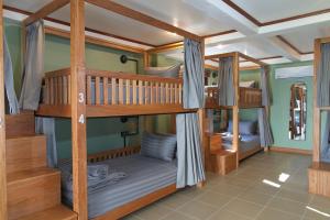 a room with bunk beds in a house at Chalok Reef Divers Hostel in Ko Tao
