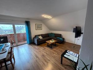 a living room with a couch and a table at Ferienwohnung Lodge 13 in Ehrenberg