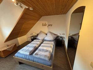 a bedroom with a bed with a wooden ceiling at Ferienwohnung Lodge 13 in Ehrenberg