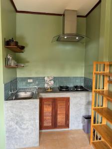 a kitchen with a sink and a stove at Chalok Reef Divers Hostel in Ko Tao +30 photos