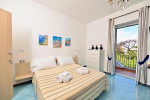 a bedroom with a bed with two towels on it at Don Giorgio Studios in Ischia Town