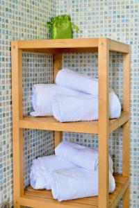 a wooden shelf with white towels on it at Don Giorgio Studios in Ischia Town +66 photos