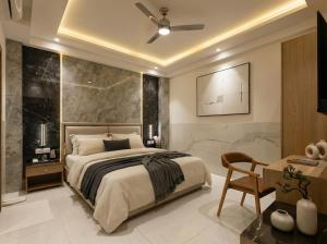 a bedroom with a king sized bed and a desk at Dahabi Airport Hotel Era in New Delhi +94 photos