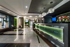 a lobby with a bar with a fish tank at Aparthotel Vanilla in Krakow