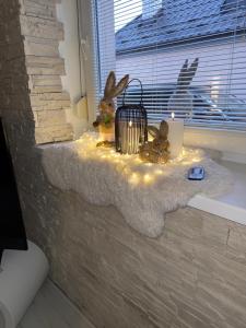 a window sill with a lantern and lights on it at Alia house with garden in Piešťany in Piešťany