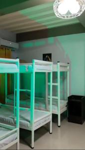 two bunk beds in a room with a ceiling at Pacifico's Hostel in Barili