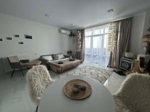a living room with a couch and a table at Touch the Coast in Batumi
