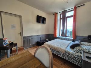a bedroom with a bed and a window at Le Berthoir in Pélussin