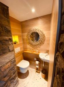 a bathroom with a toilet and a sink at ROMANTIC SUlTE WITH ITS OWN SPA AND OPEN VIEW TO LUGANO in Cademario