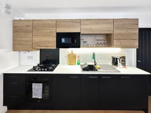 a kitchen with a black and white counter top at Brontë Country 4 Bed Retreat with Fireplace in Oakworth