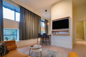 a living room with a couch and a flat screen tv at The Malt Store in Birr