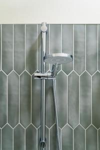 a stool in a bathroom with a tile wall at The Malt Store in Birr +30 photos