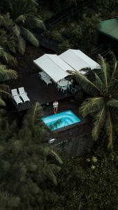 an overhead view of a swimming pool with a person standing next to it at South Point Villas Cerf Island in Cerf Island