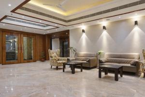 a lobby with couches and chairs and a ceiling at Hotel Mandovin - A Premium Hotel In Udaipur in Udaipur