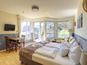 a bedroom with a large bed and a living room at Ferienhaus Bullay in Bullay