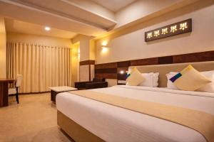 a hotel room with a bed and a desk at Hotel Mandovin - A Premium Hotel In Udaipur in Udaipur
