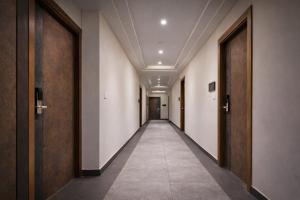 a corridor of a hallway with doors at Hotel Mandovin - A Premium Hotel In Udaipur in Udaipur +29 photos