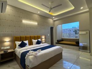 a bedroom with a large bed and a window at Hotel The Merc in Kharar