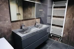 a bathroom with a sink and a mirror at Weromerie Premium Hotel and Apartment in Wormer +103 photos