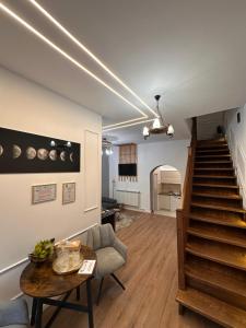 a living room with a staircase and a table at Norderney Apartments in Sibiu