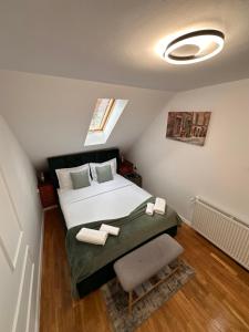 a bedroom with a large bed and a window at Norderney Apartments in Sibiu