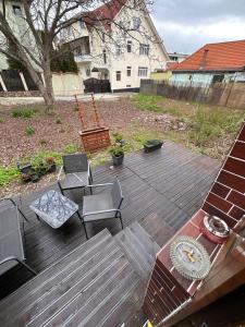 a wooden deck with chairs and a table at Norderney Apartments in Sibiu
