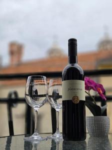 a bottle of wine and two glasses on a table at Guesthouse Ivan in Skradin