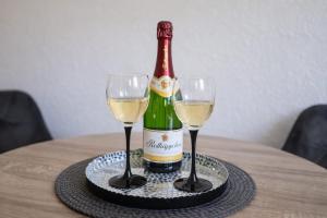a bottle of wine and two glasses on a table at Ferienwohnung Czampiel in Havelberg +14 photos