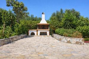 a brick road with a small building in the middle at Dora Apartments in Tragaki