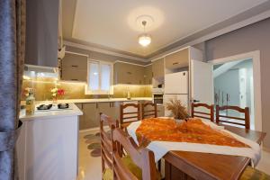 a kitchen and dining room with a table and chairs at Villa Egeden 2 in Fethiye