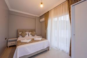 a bedroom with a bed and a large window at Villa Egeden 2 in Fethiye +17 photos