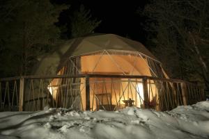 a dome tent in the snow at night at Anima Resort Aghveran - Forest Retreat in Aghveran